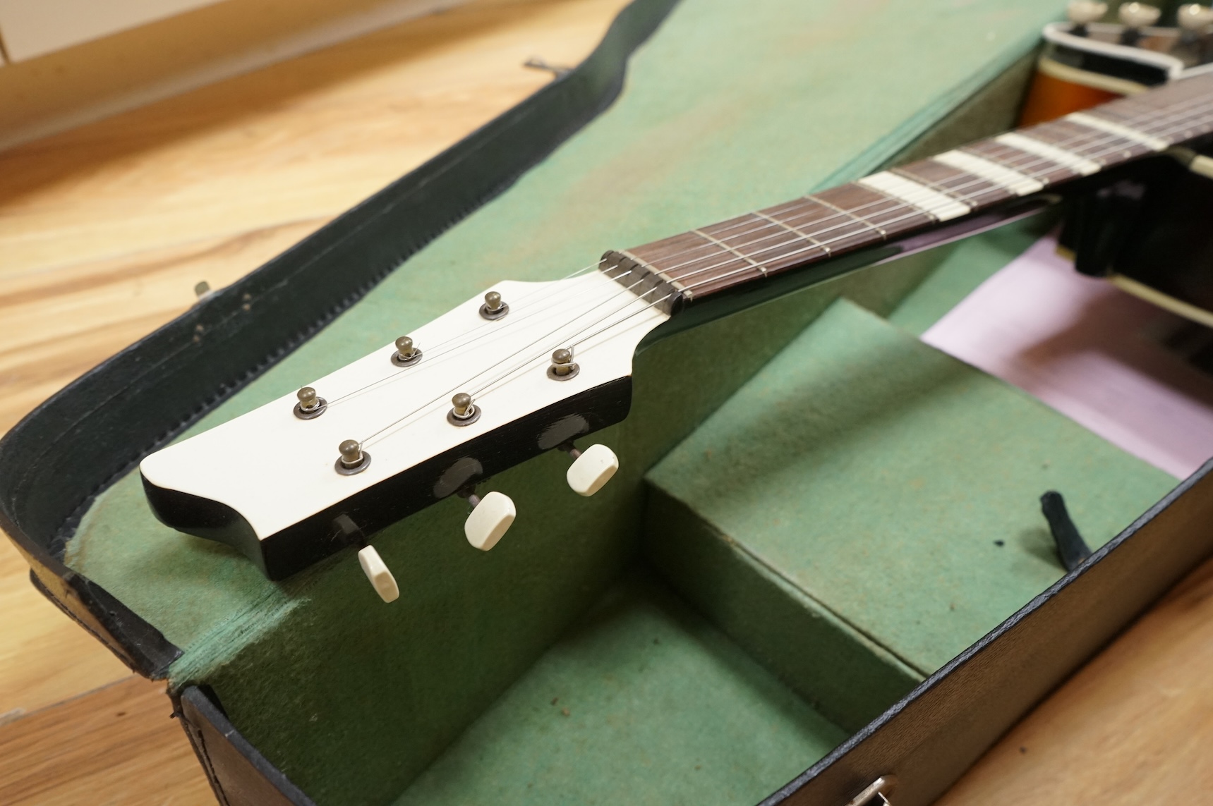 A 1950's Hofner style cut-away acoustic guitar, fitted with a pick up bearing Hofner engraved signature, with hard case.